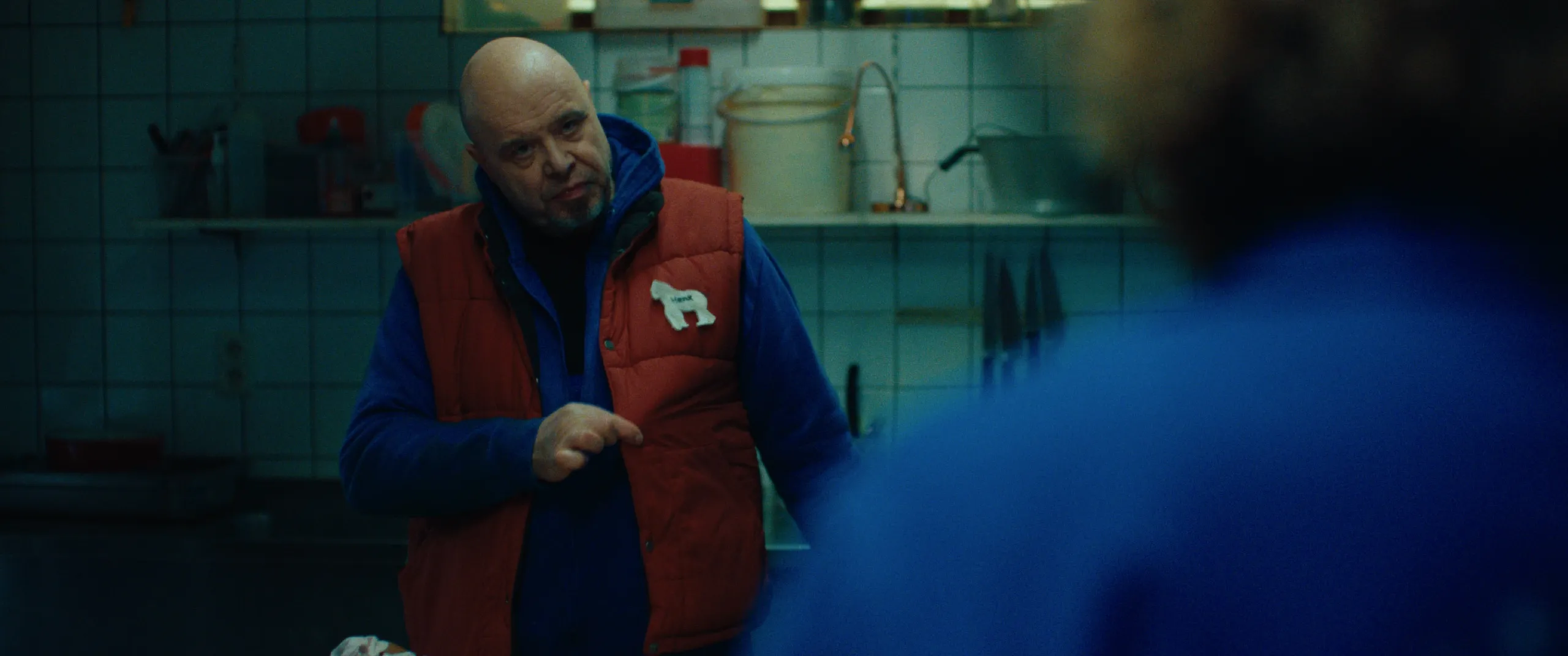 Vlinderman: the keeper in the red bodywarmer makes a point in the tiled zoo kitchen