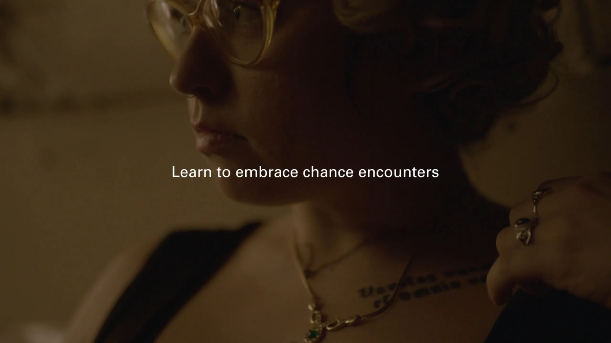 Chance Encounters: profile of a tattooed woman in glasses and cross necklace, titled learn to embrace chance encounters