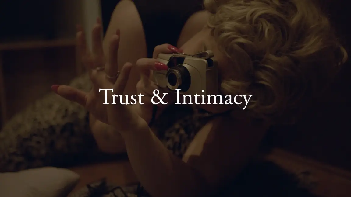 Chance Encounters: blonde woman lying down shooting an Olympus compact camera, Trust and Intimacy titled