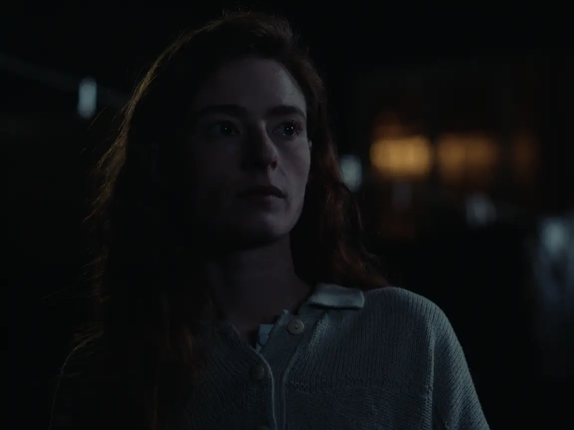 Moonlight Woman: Sarah stands in near darkness, her face half lit as she listens