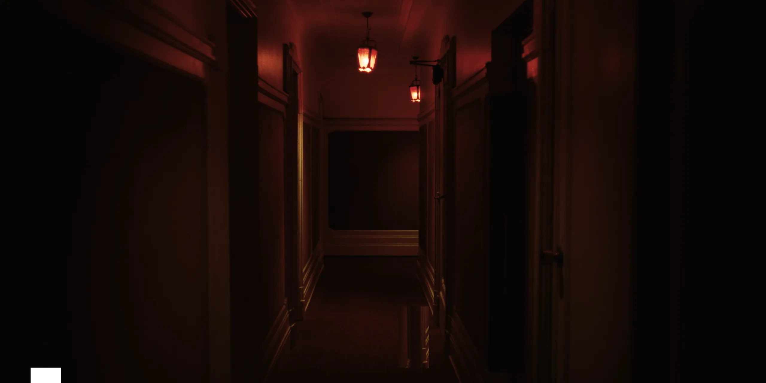 The Tears of Things: an empty apartment hallway glowing under warm red lamplight at night