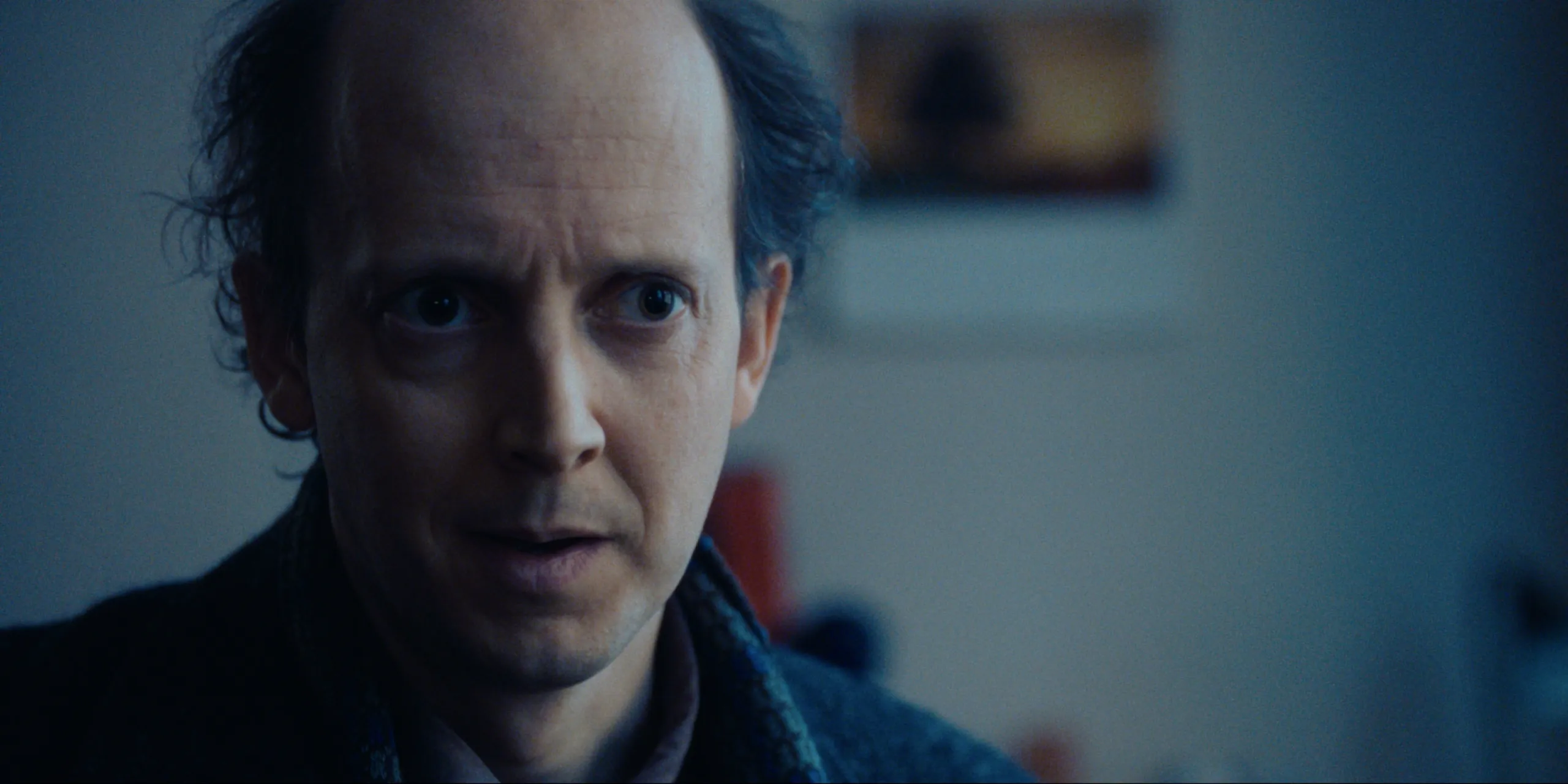 Bearer of Bad News: close-up of Sven, eyebrows raised and eyes anxious in cold blue light